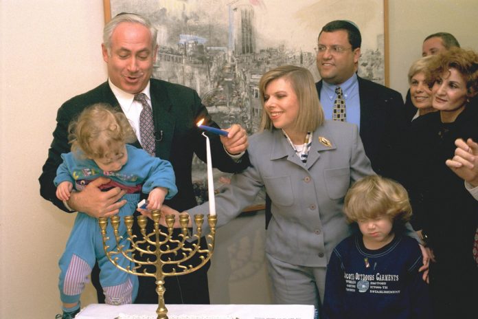 Netanyahu Lighting Hanukah Candles with His Wife and Sons